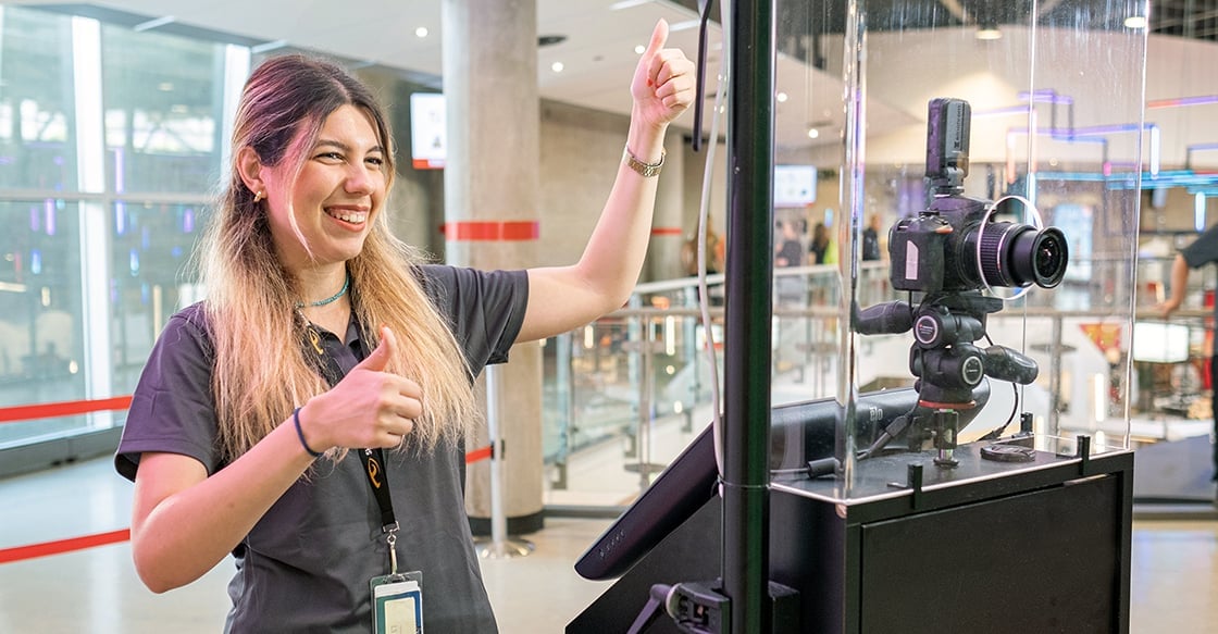 Digital Attractions team member helping a guest
